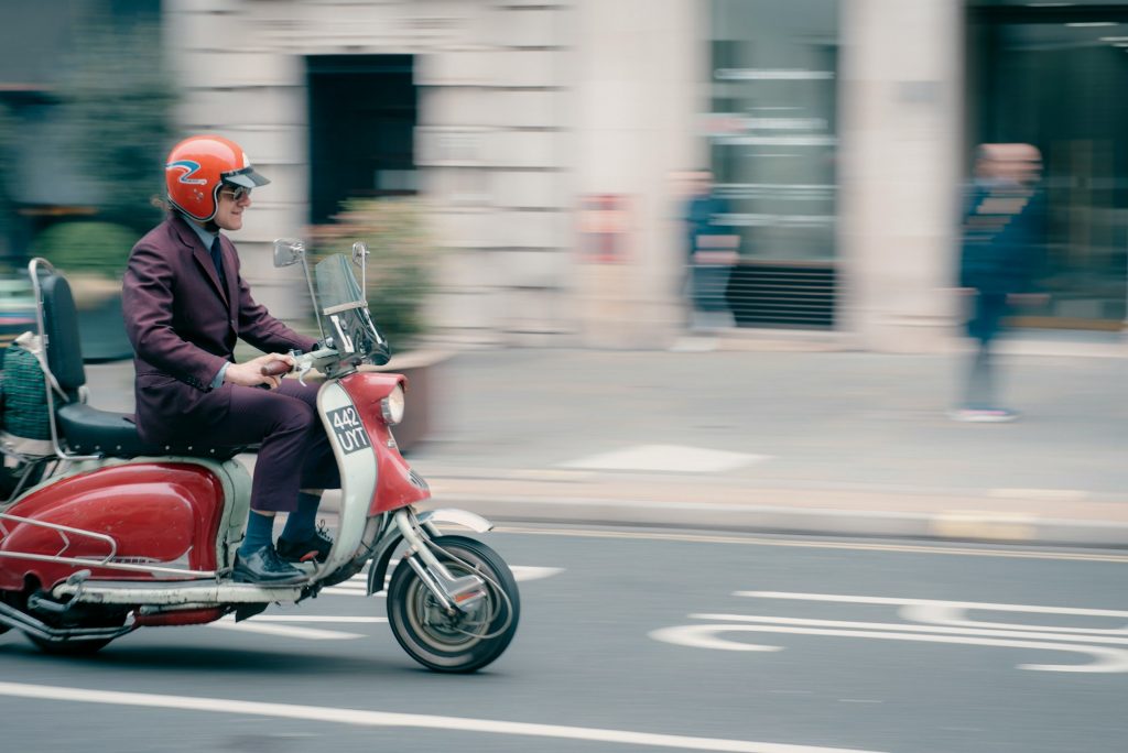person-riding-a-scooter-on-the-street-NtwNkvLQkt8