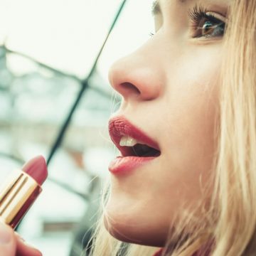 selective-focus-photography-of-woman-holding-lipstick-F4AMM1293ag