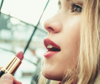 selective-focus-photography-of-woman-holding-lipstick-F4AMM1293ag