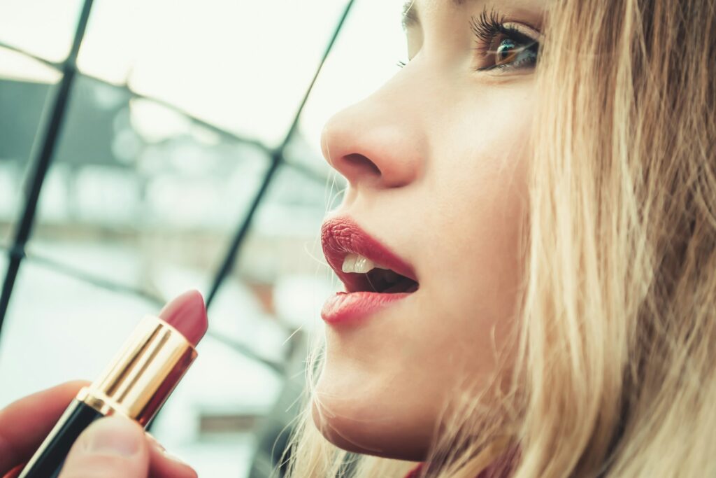 selective-focus-photography-of-woman-holding-lipstick-F4AMM1293ag