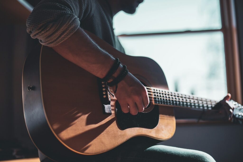 man-playing-acoustic-guitar-selective-focus-photography-hUHzaiAHuUc