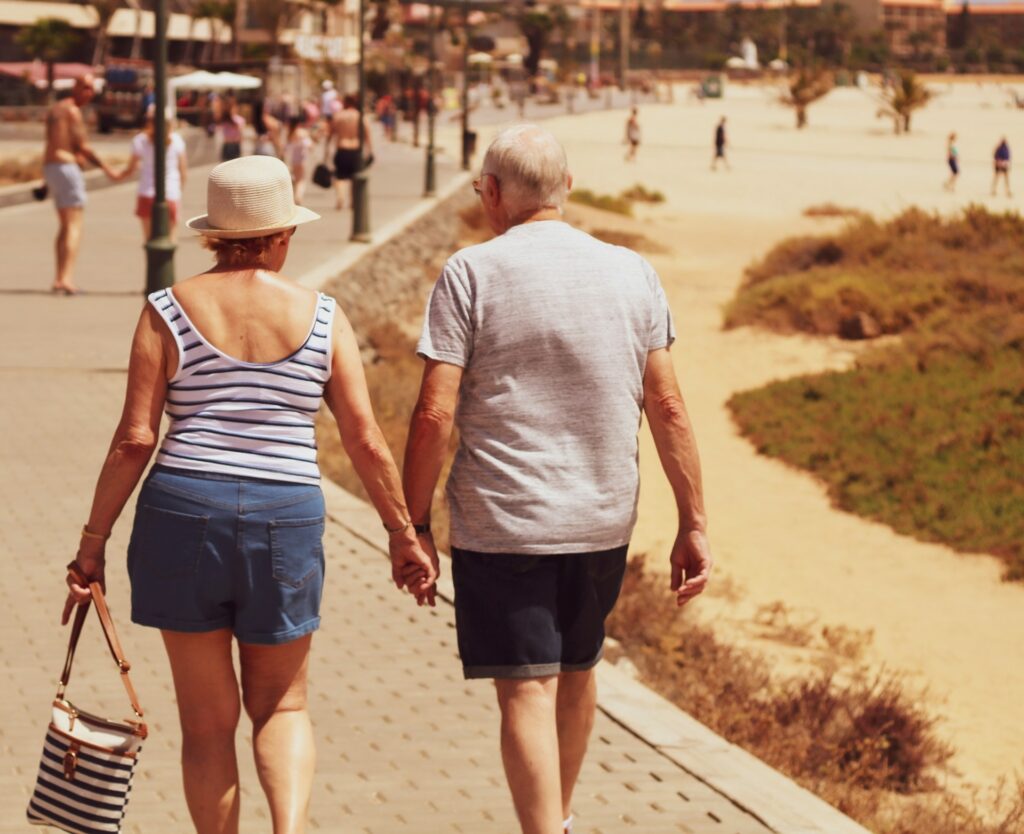 man-and-woman-walking-on-road-while-holding-hands-DLLpNmIG0pk