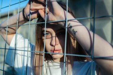 photo-of-woman-leaning-on-screen-fence-2926249/