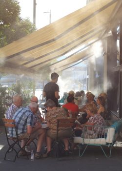 a-group-of-people-sitting-around-a-table-under-a-canopy-ha9aYwpCx1k