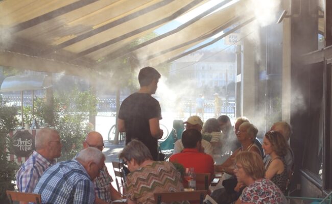 a-group-of-people-sitting-around-a-table-under-a-canopy-ha9aYwpCx1k