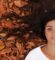 woman-lying-on-ground-with-brown-leaves-98DhcSEWWSg