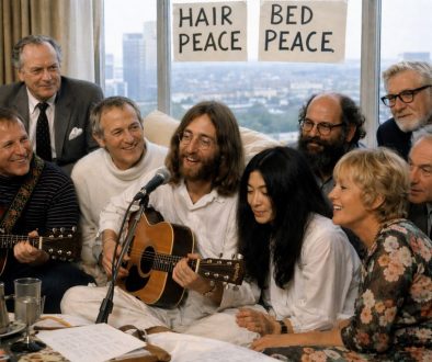 recriação artística de John Lennon, Yoko Ono e convidados a gravarem Give Peace a Chance num quarto de hotel em Montreal em 1969