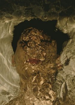 a-man-swimming-in-a-pool-of-water-2ZQGImk47yA