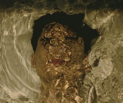 a-man-swimming-in-a-pool-of-water-2ZQGImk47yA